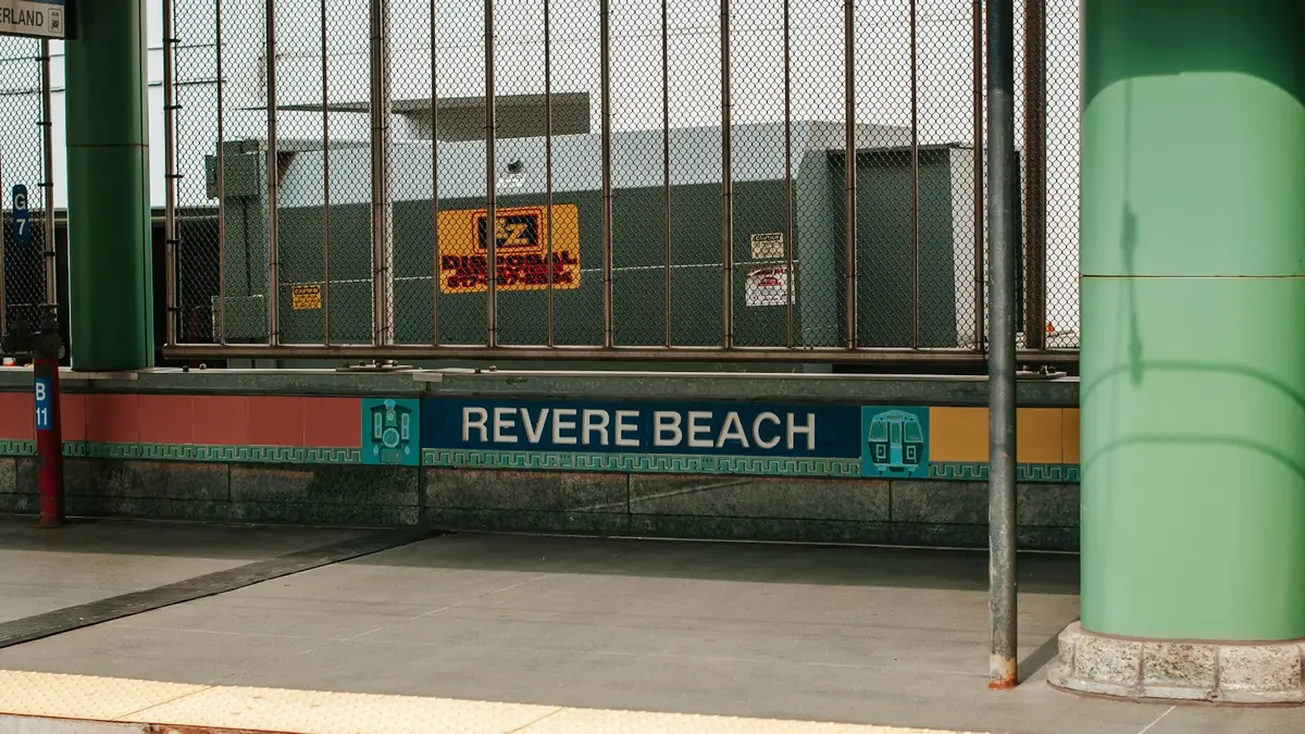 The Revere Beach sign on the platform of the MBTA station - Leak Detection in Revere